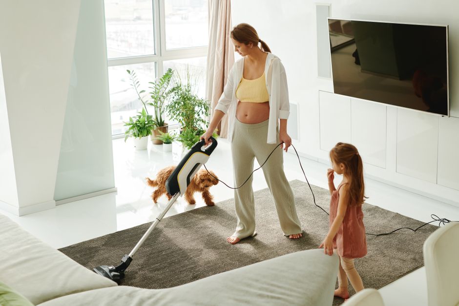 Vacuuming living room carpet